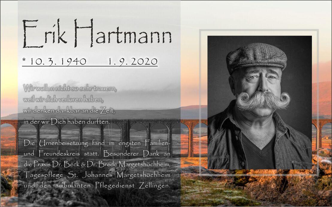 Bild eines Nachrufs für Erik Hartmann mit Lebensdaten und persönlicher Botschaft unter einem sanften Landschaftshintergrund.